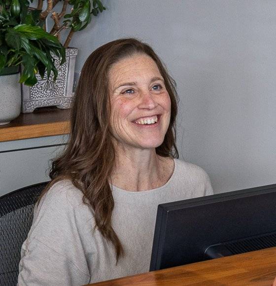 Ami Johnson smiling at the front desk
