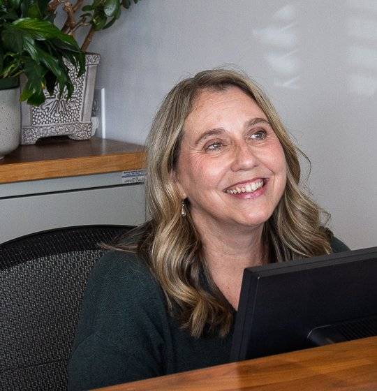 Bonnie Lindsay smiling at the front desk