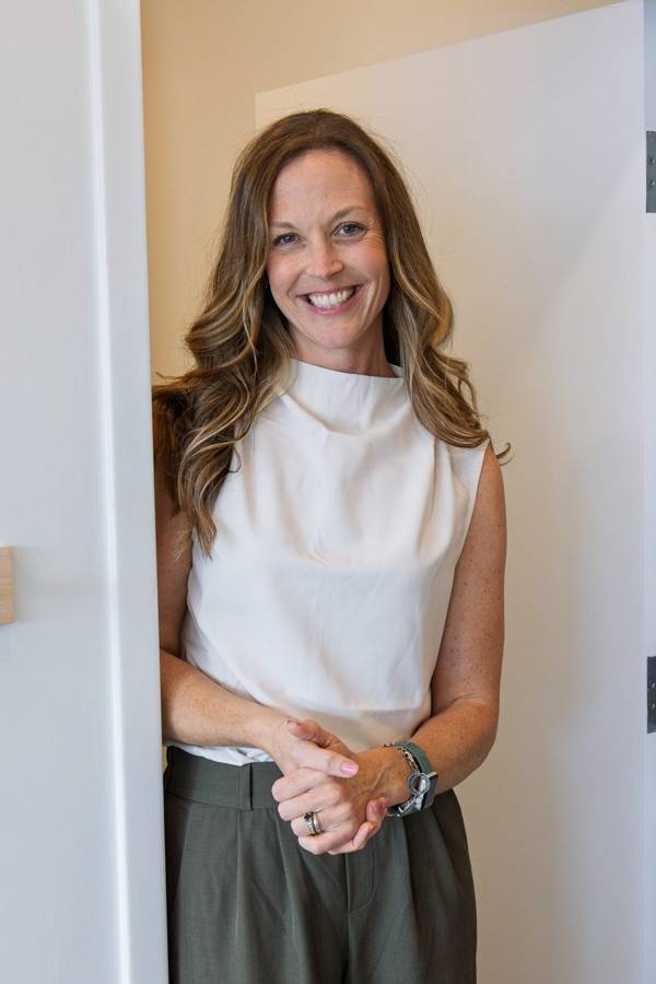 Dr. Nicole Craze smiling in a clinic doorway