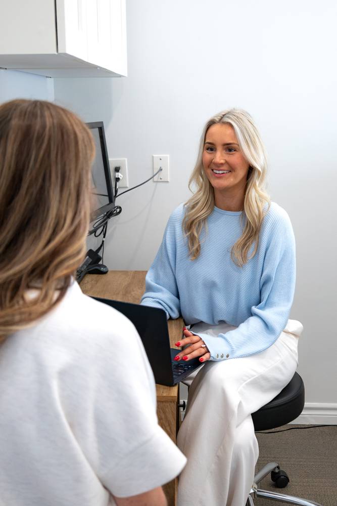 A practitioner smiling during a one-on-one wellness consultation